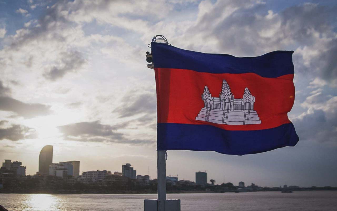 a Cambodian flag waving in the wind on a ferry