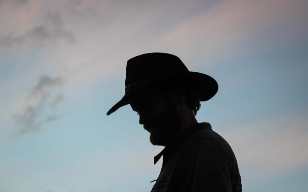 silhouette of man with a cowboy hat