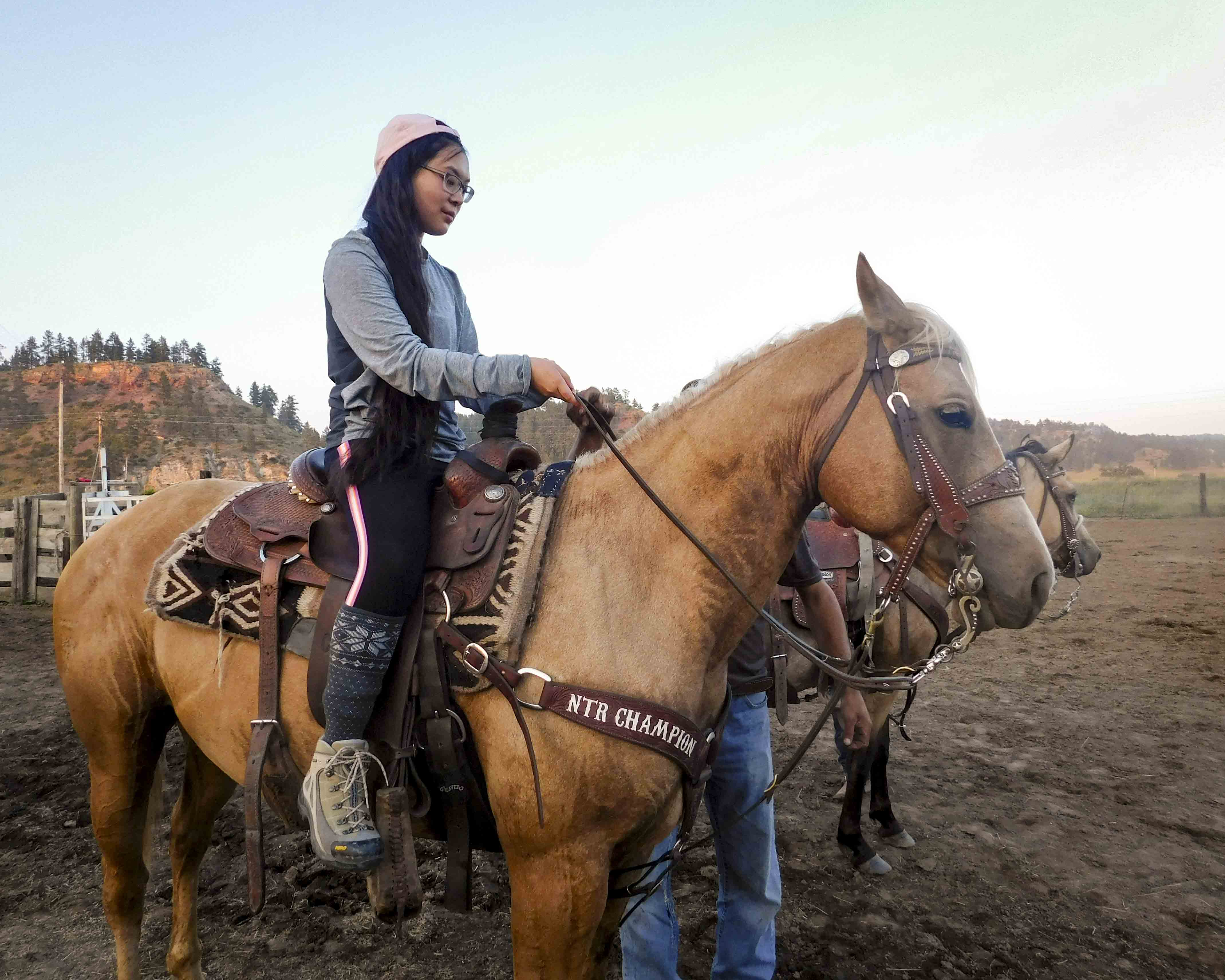 Teenage girl rides horse for the first time on community service trips to the Northern Cheyenne