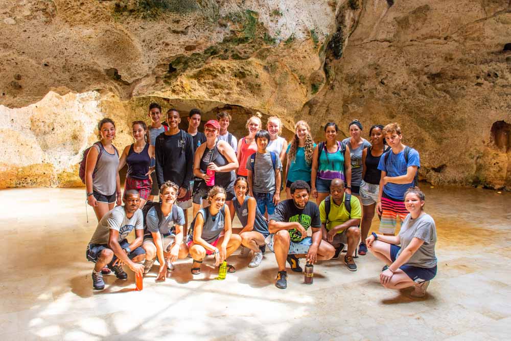 A group of teen volunteers in a beach cave in the Dominican Republic.