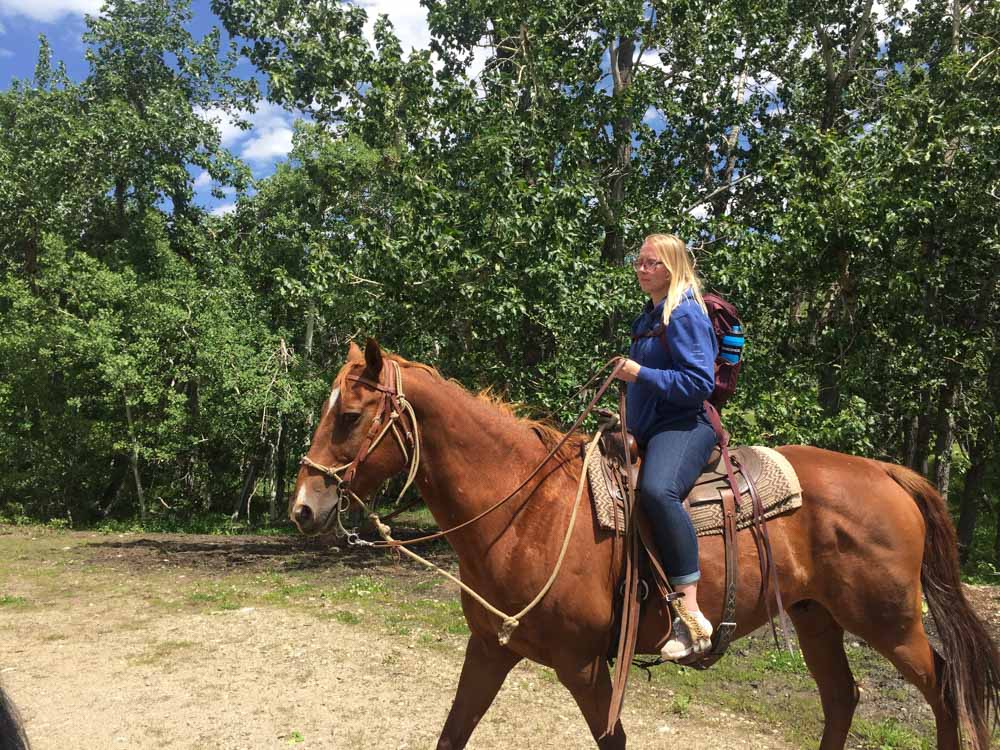 VISIONS leader Gen riding a horse in Montana.