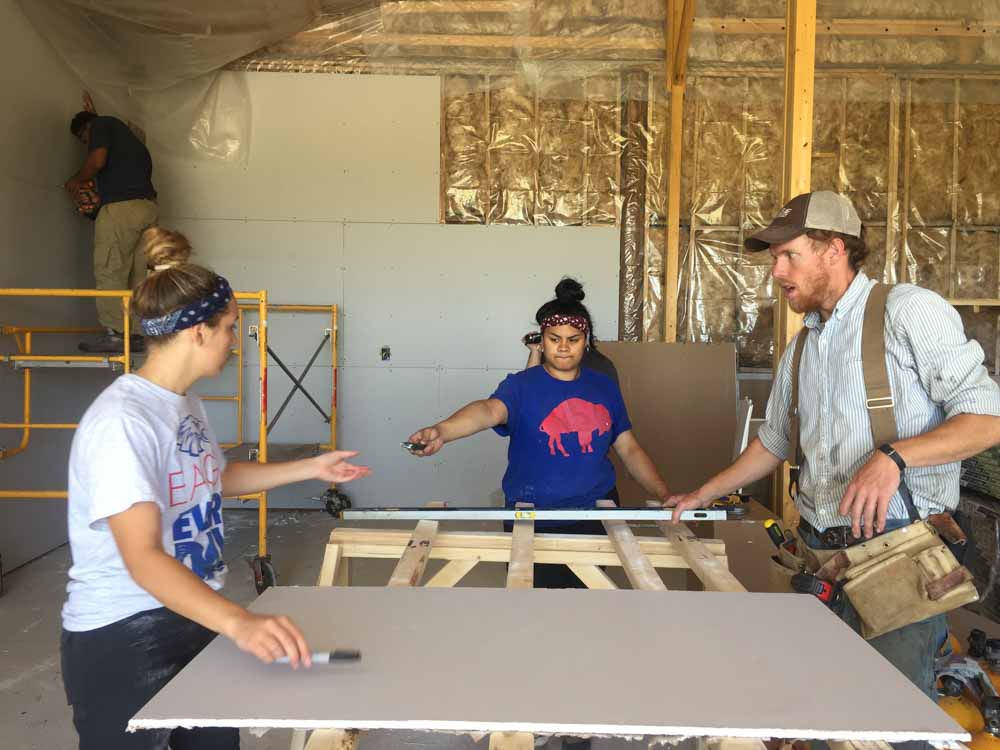 VISIONS leader works with teen volunteers on a summer service project.