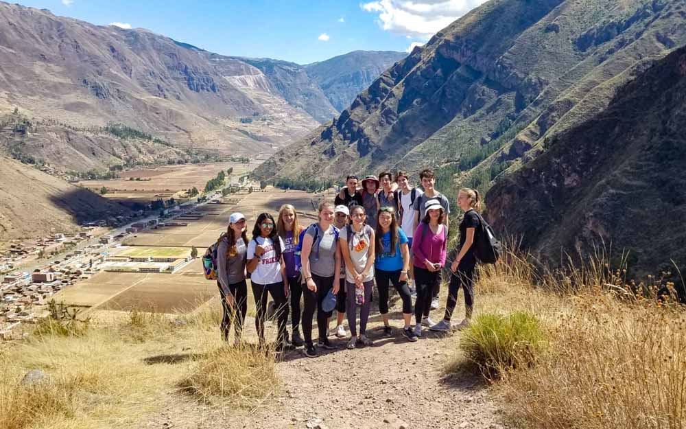 Group of volunteers hiking in Pisac, Peru during a break on their summer service trip.