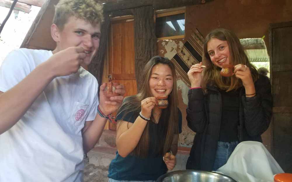 Students tasting hot cocoa in Peru.