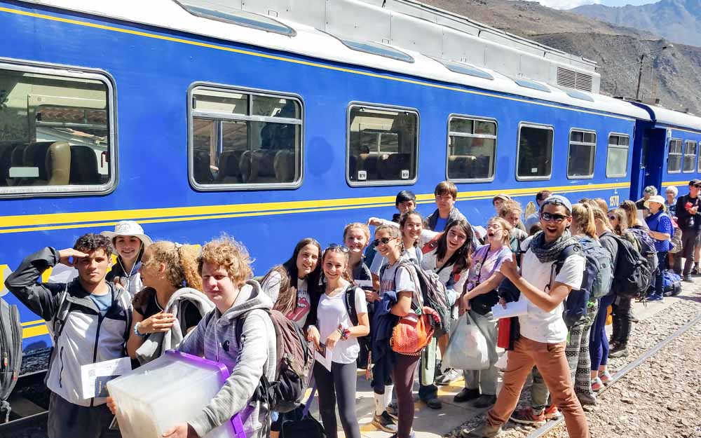 Group of students boarding the train to Machu Picchu on Peru summer service trip.