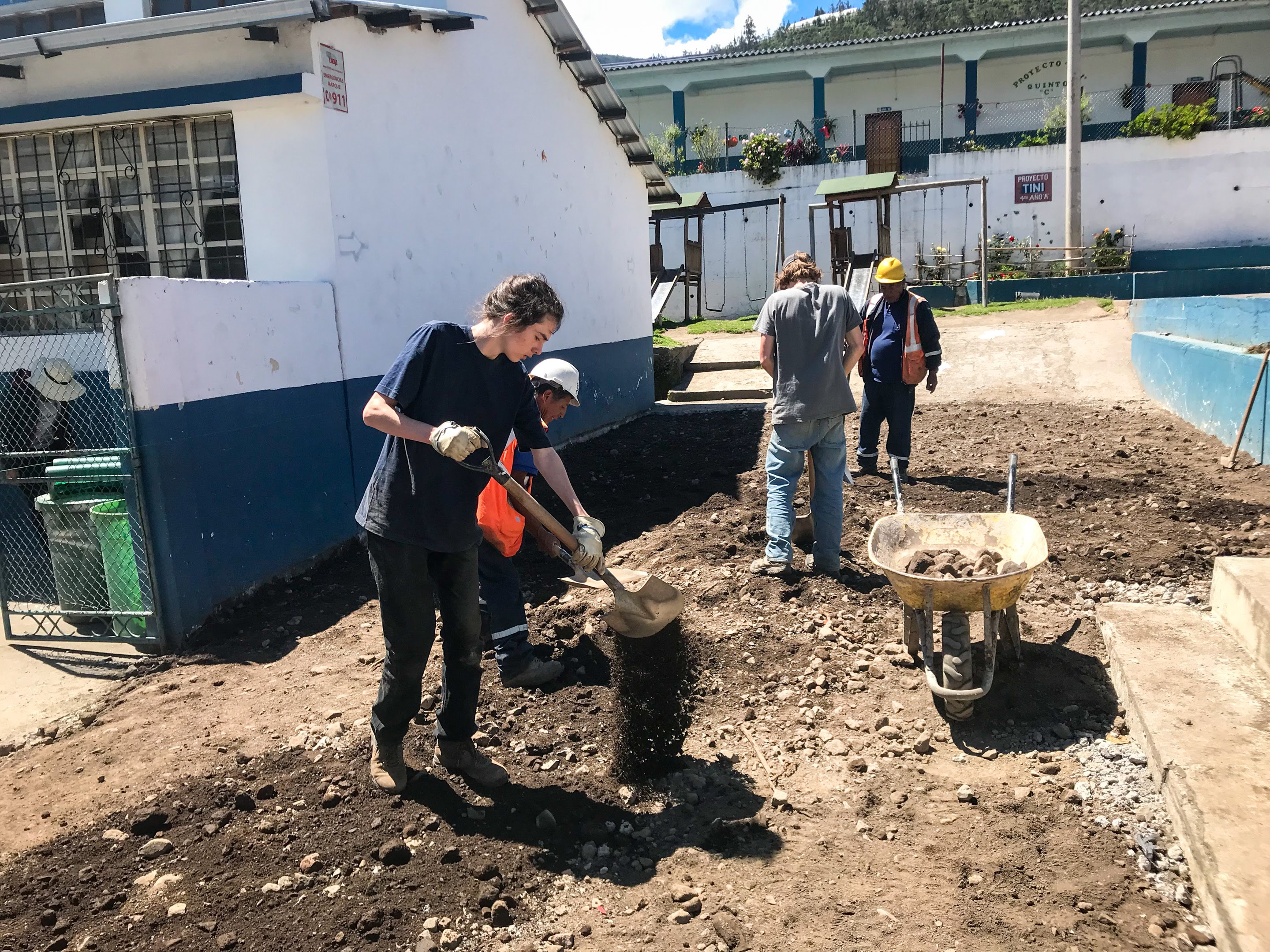 Group of teen volunteers help local volunteers lay cement for community service project in Ecuador