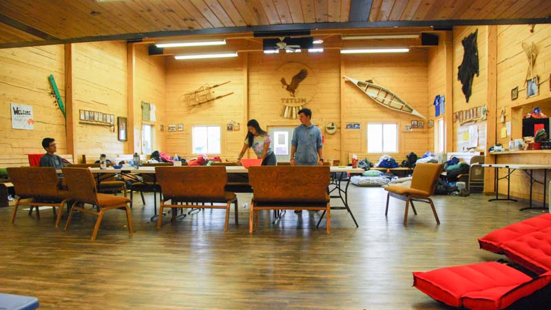 Teens set places for dinner in their home away from home in Alaska