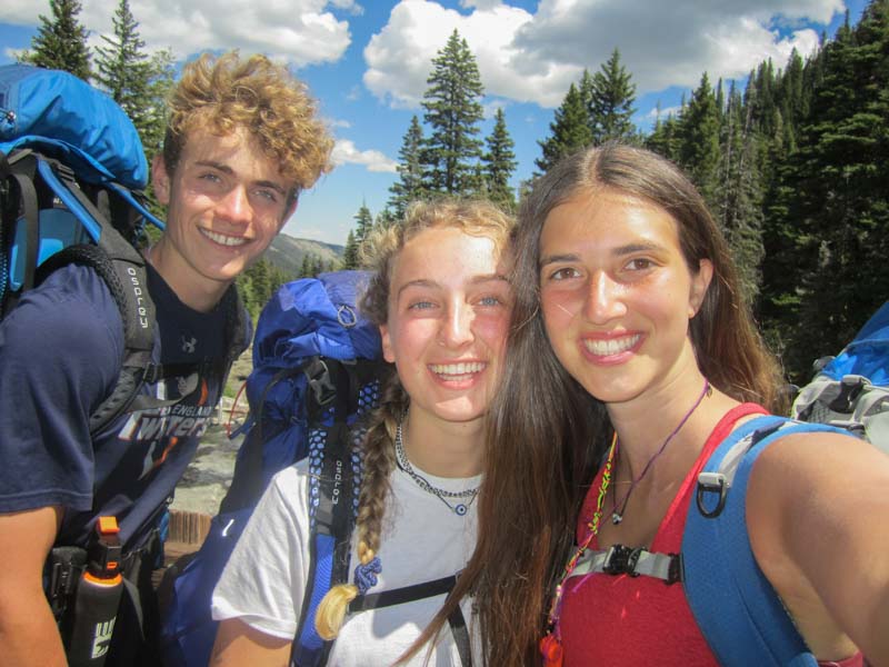 High school students smile with their overnight backpacks on in Montana.