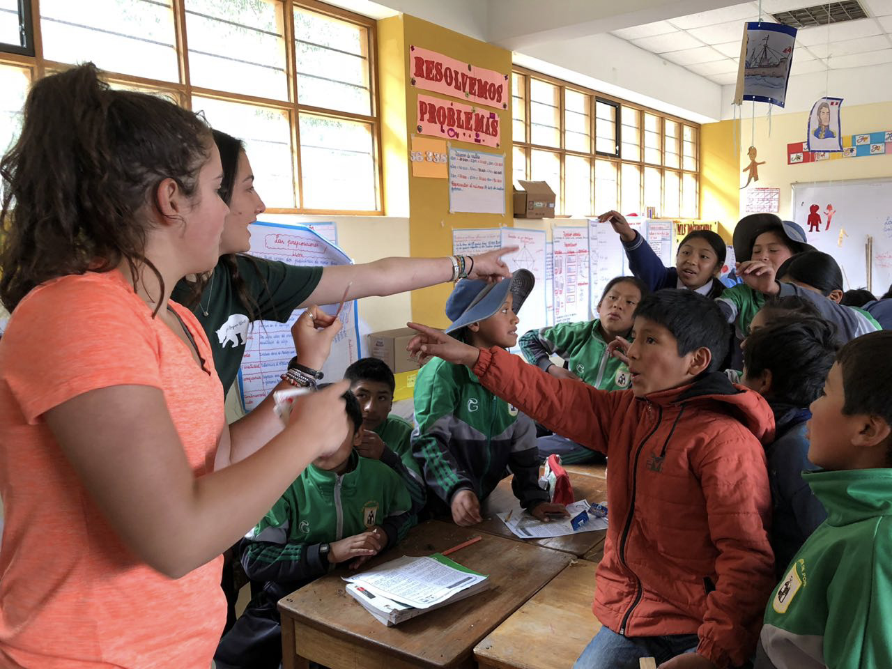 Teen volunteers play a classroom game with enthusiastic middle school kids in Peru