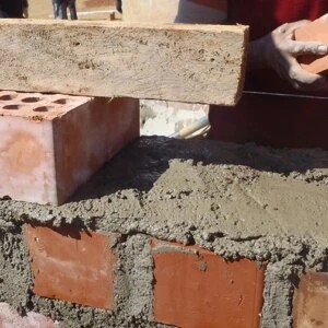 VISIONS Peru working with community members to build schoolhouse
