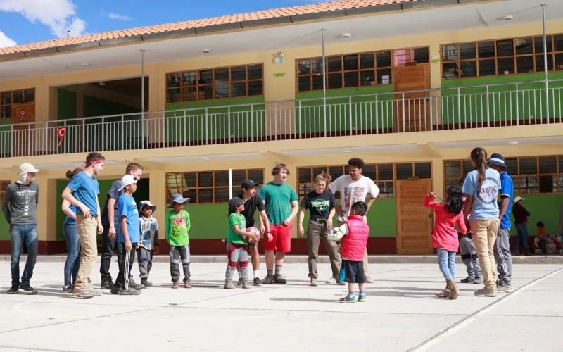 high school volunteers playing soccer with local Peruvians in Peru