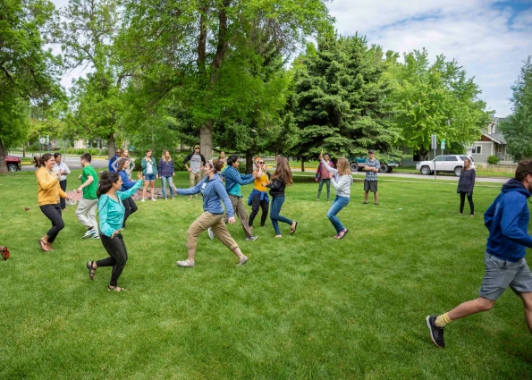 Visions leaders from around the world run around a lawn in team-building exercise