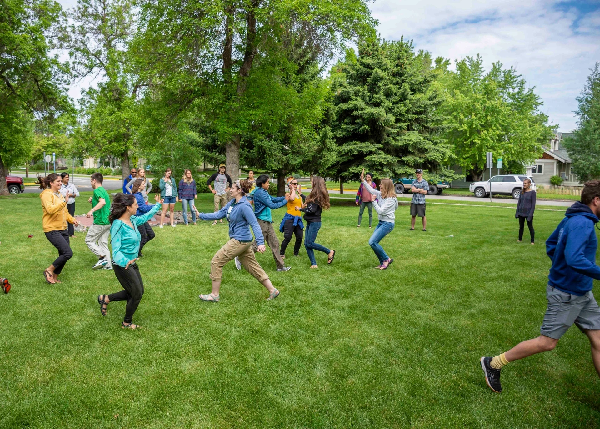 Visions leaders from around the world run around a lawn in team-building exercise