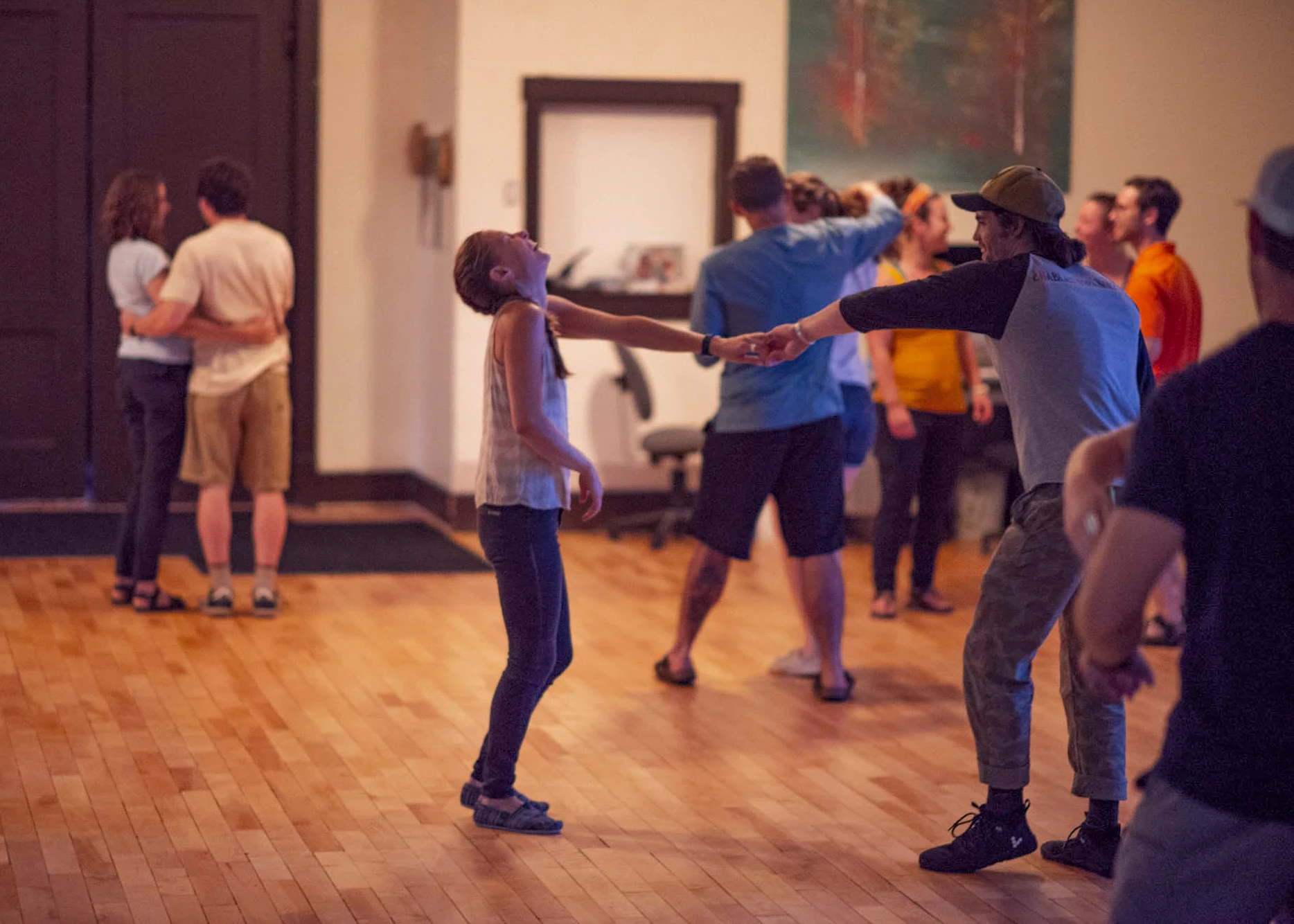 Visions leaders from around the world laugh while dancing bachata
