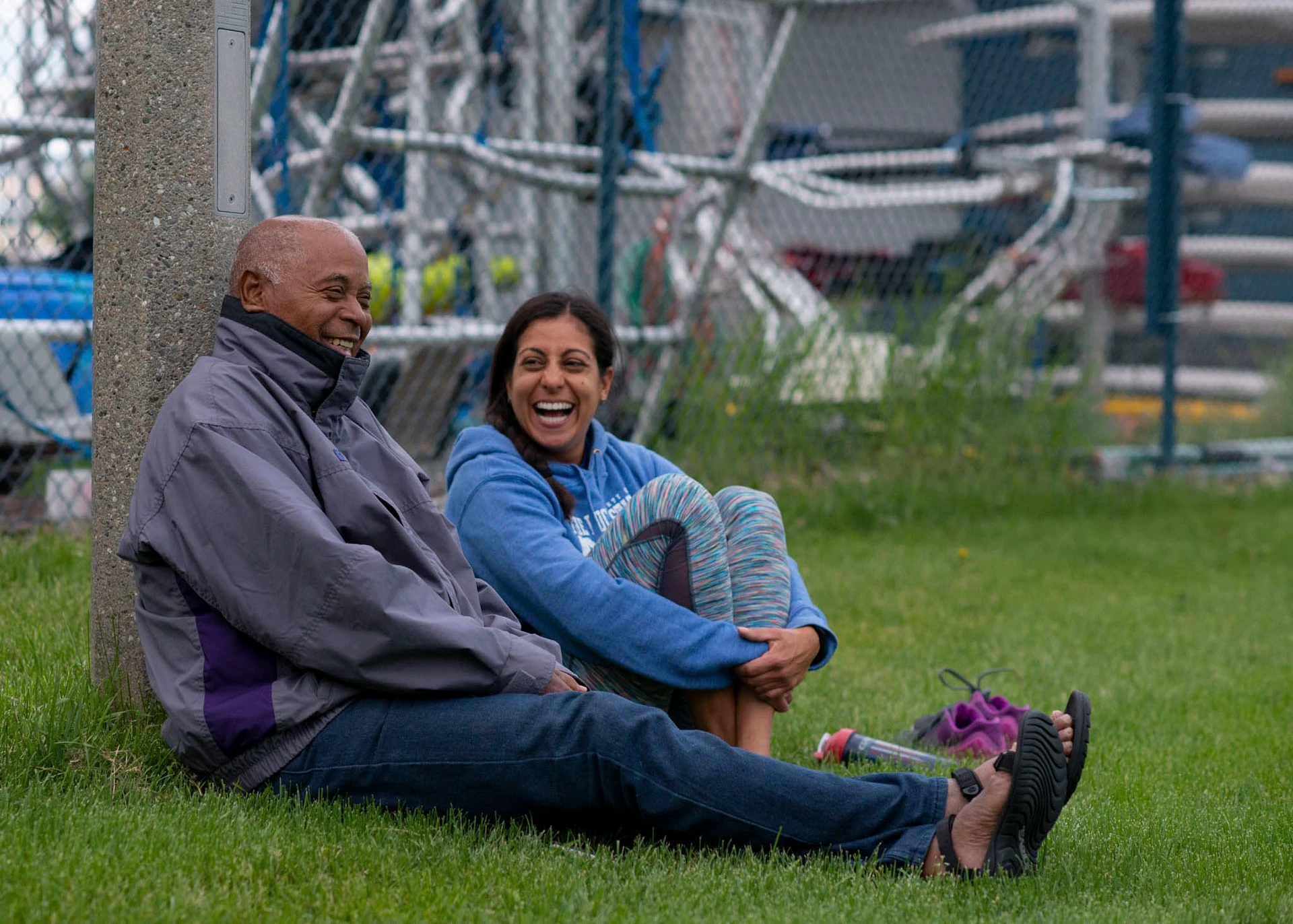 Visions leaders from around the world laugh while sitting on the grass