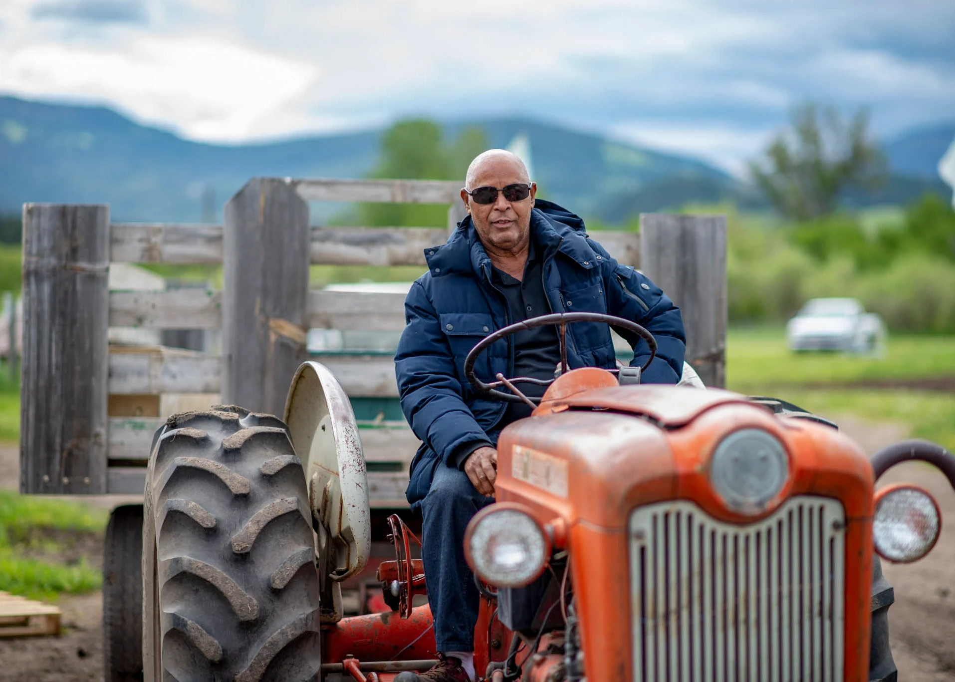 VISIONS leader from the Dominican Republic sits on tractor in Montana