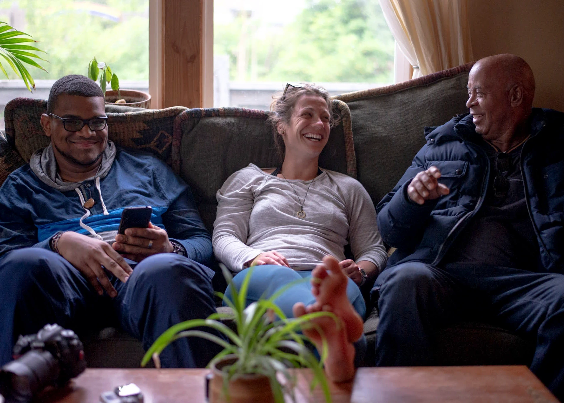 VISIONS leaders from around the world sit on a couch and laugh together