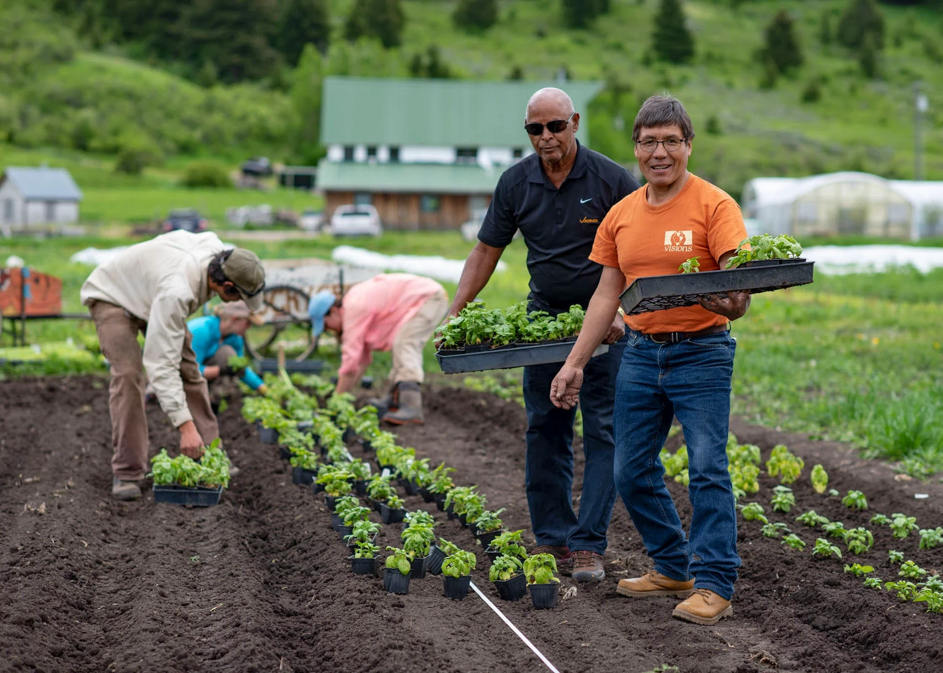 VISIONS leaders from around the world plant vegetables at farm