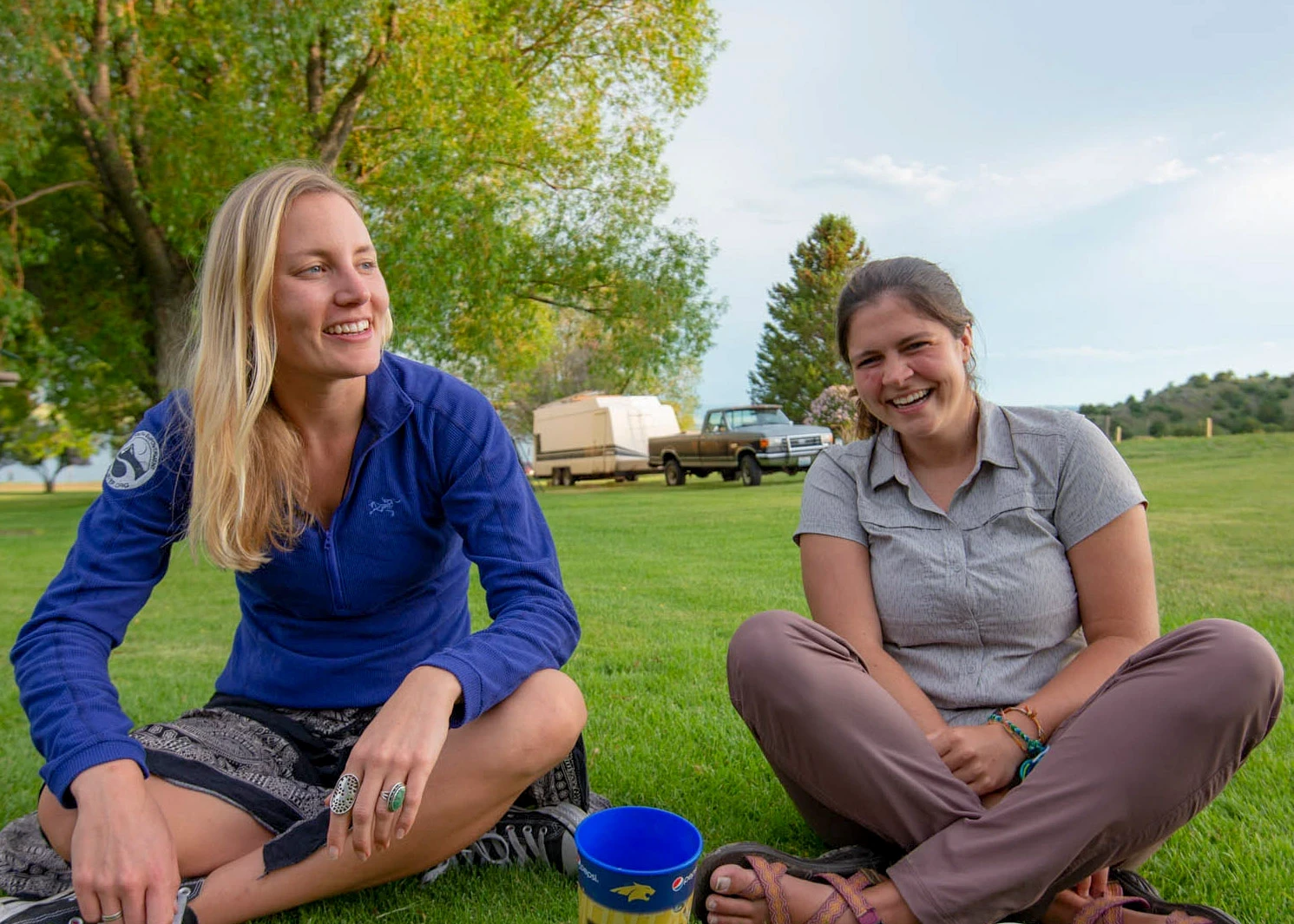 Visions leaders from around the world laugh while sitting on lawn