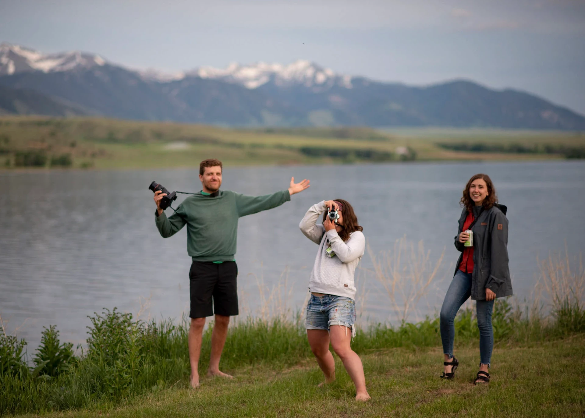 Visions leaders from around the world takes pictures by an alpine lake