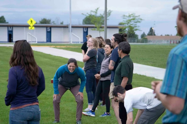 Visions leaders from around the world laugh on the sidelines of a kickball game