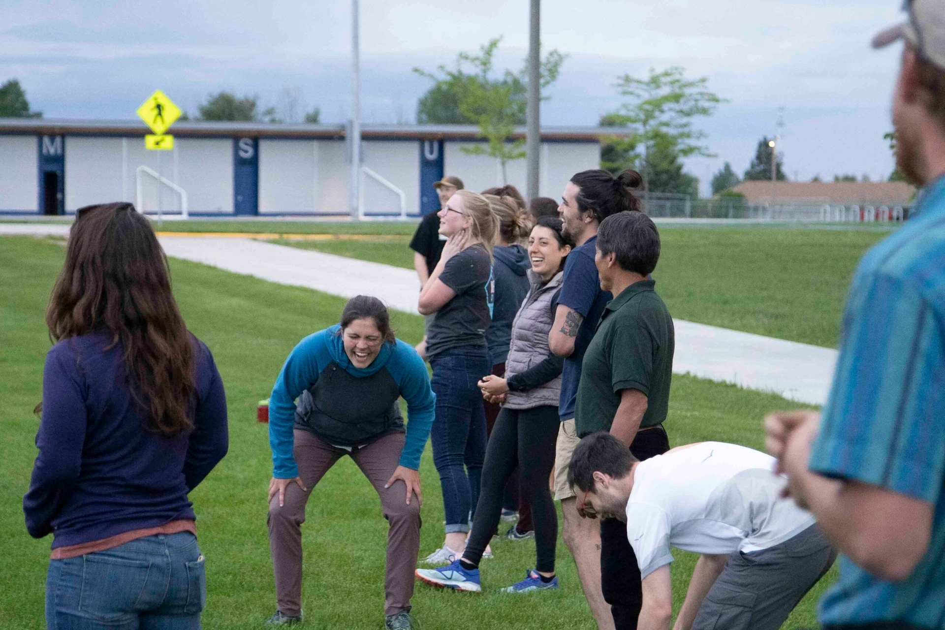Visions leaders from around the world laugh on the sidelines of a kickball game