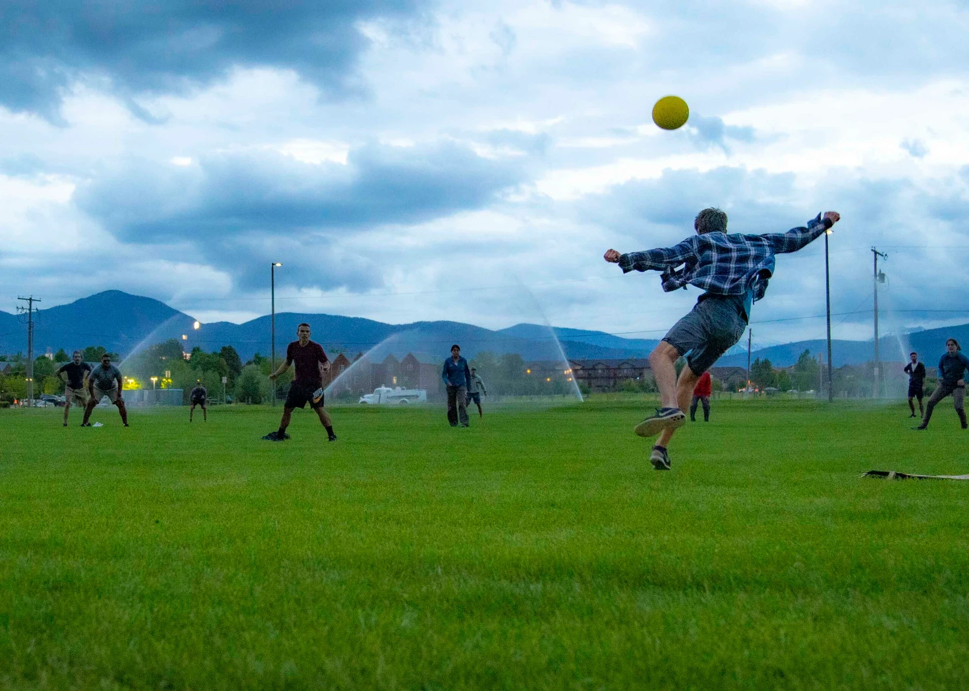Visions leader kicks ball into the air at dusk