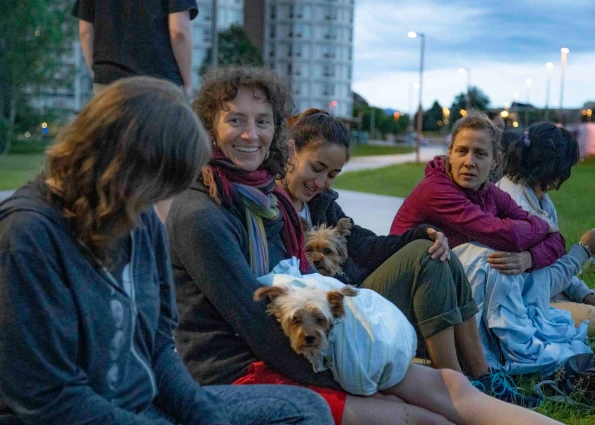 Visions leaders from around the world sit and talk with small dogs on their laps
