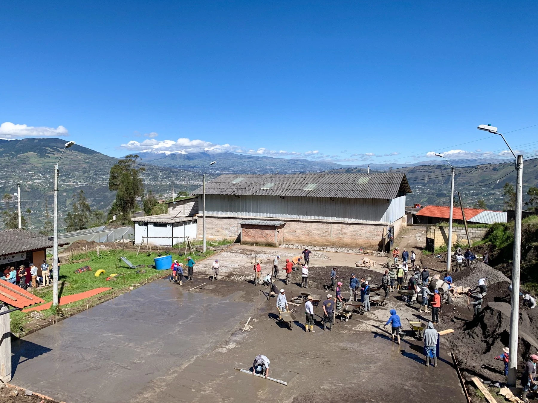 Community service project to restore soccer pitch with mountains in the background