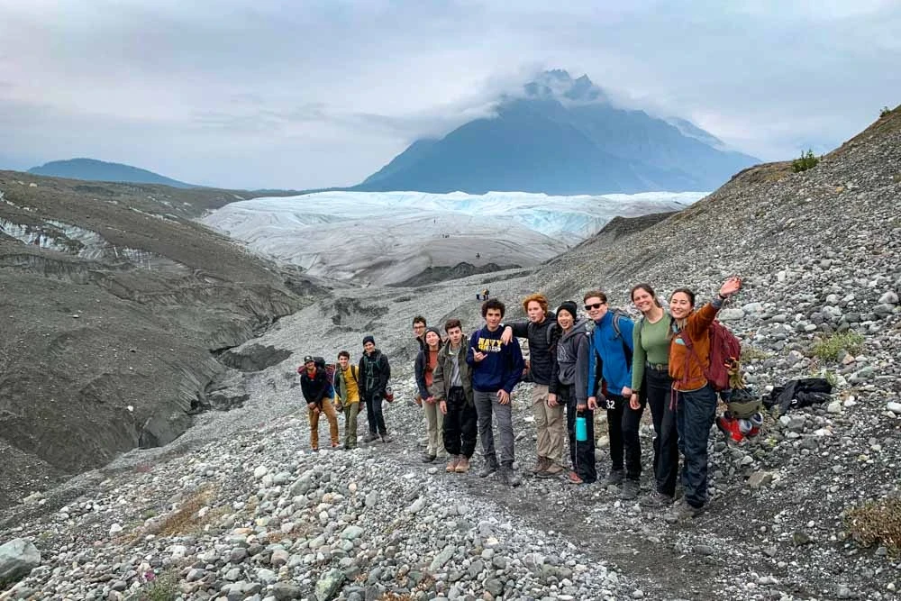 Group hiking towards glacier in McCarthy, Alaska on a day off from their teen service trip.