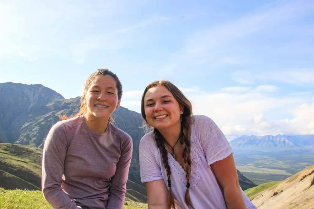 Two teens smile while on the trips