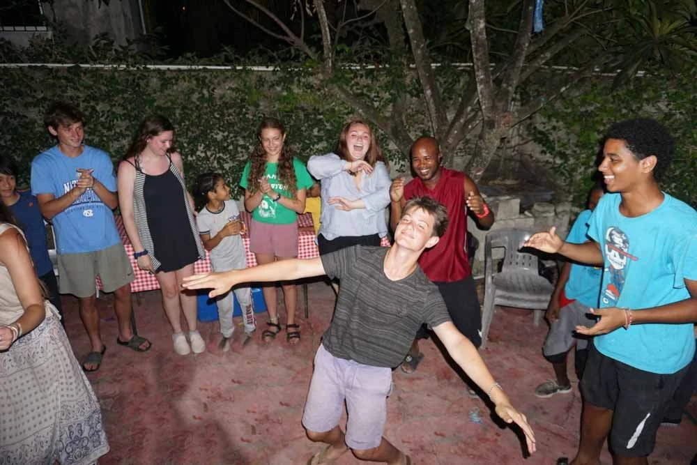 A group of teens trying out new dance moves at night.