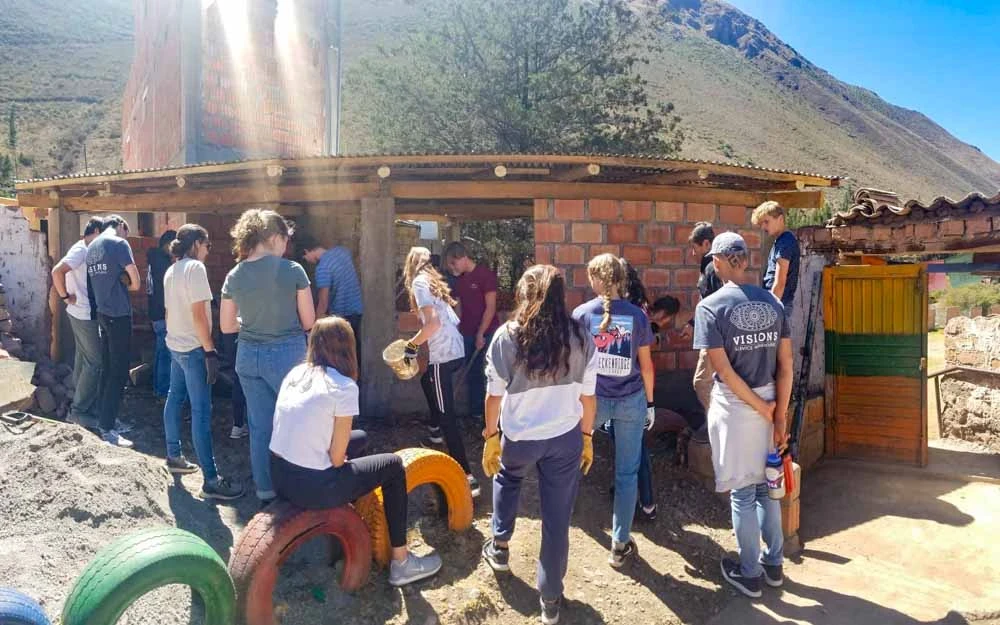 Group of volunteers constructing a school on a Peru summer service trip.