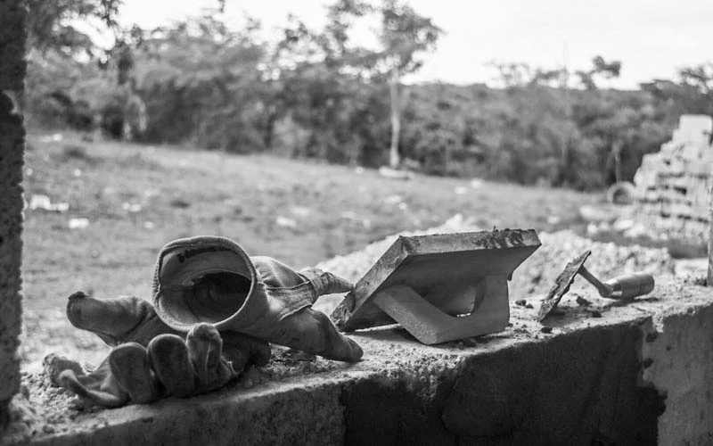 Masonary tools and gloves rest in window sill in the Dominican Republic