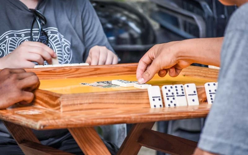 Teens play dominoes