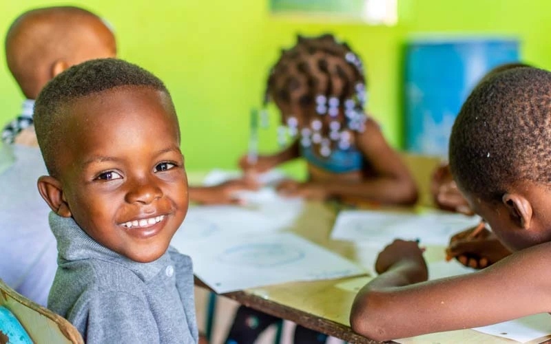 School children in the Dominican Republic draw pictures with teen volunteers