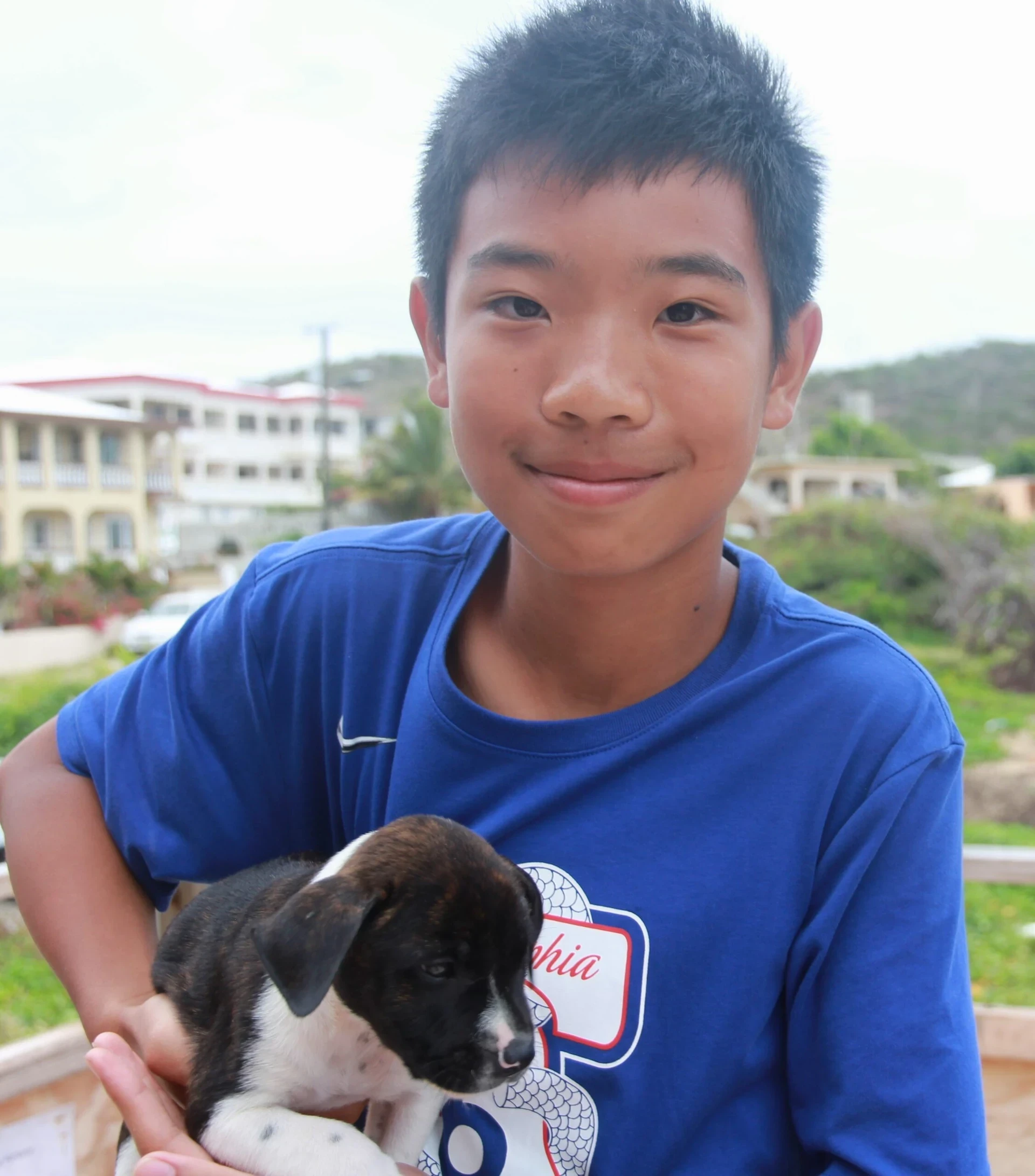 VISIONS-volunteer-holds-a-puppy-2-scaled