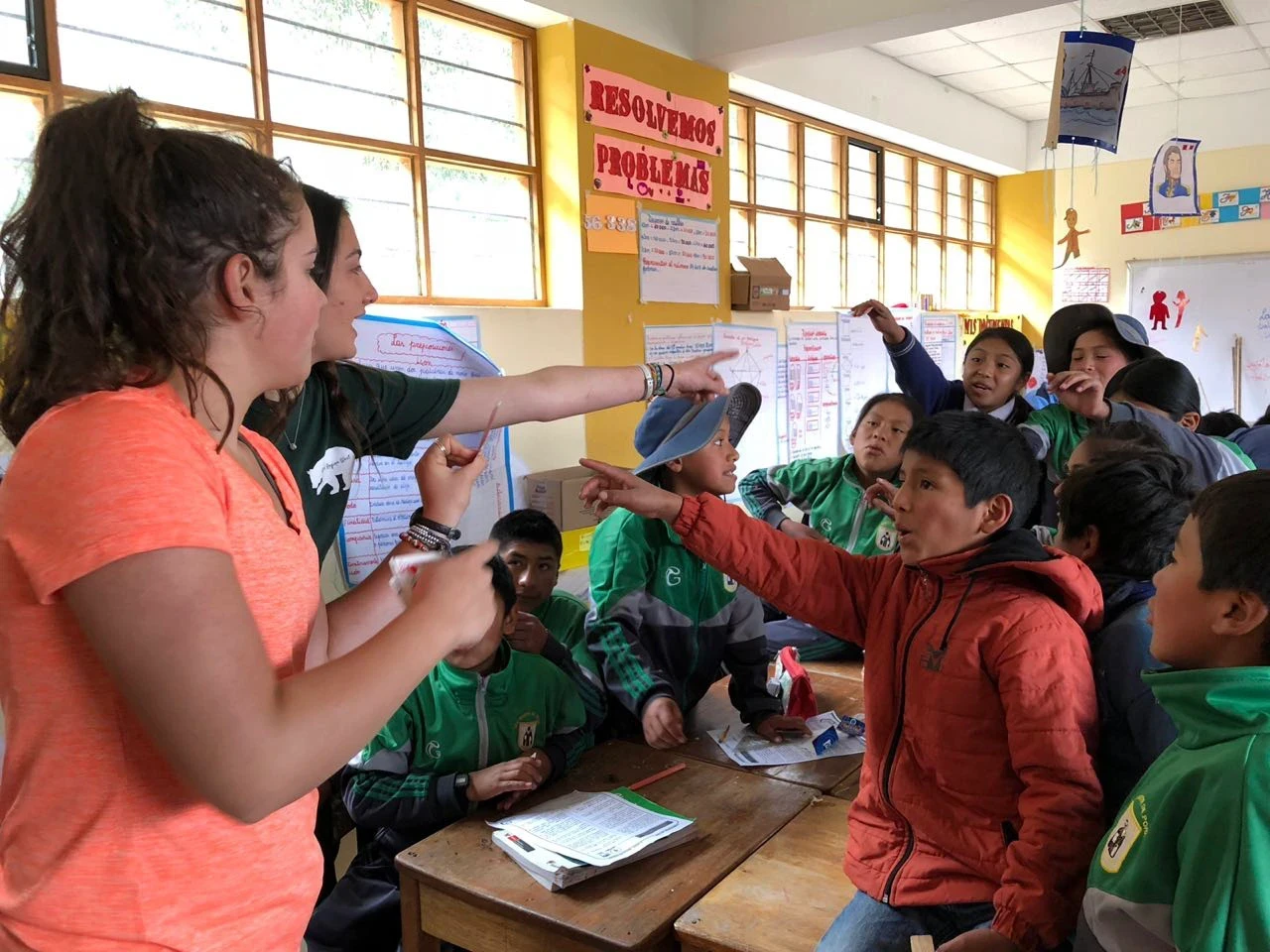 Teen volunteers play a classroom game with enthusiastic middle school kids in Peru