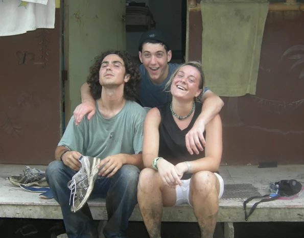 Three VISIONS summer leaders covered in mud take a moment for a picture on the front porch Anni, a VISIONS summer leader alum, with her husband and two children in Austin, TX