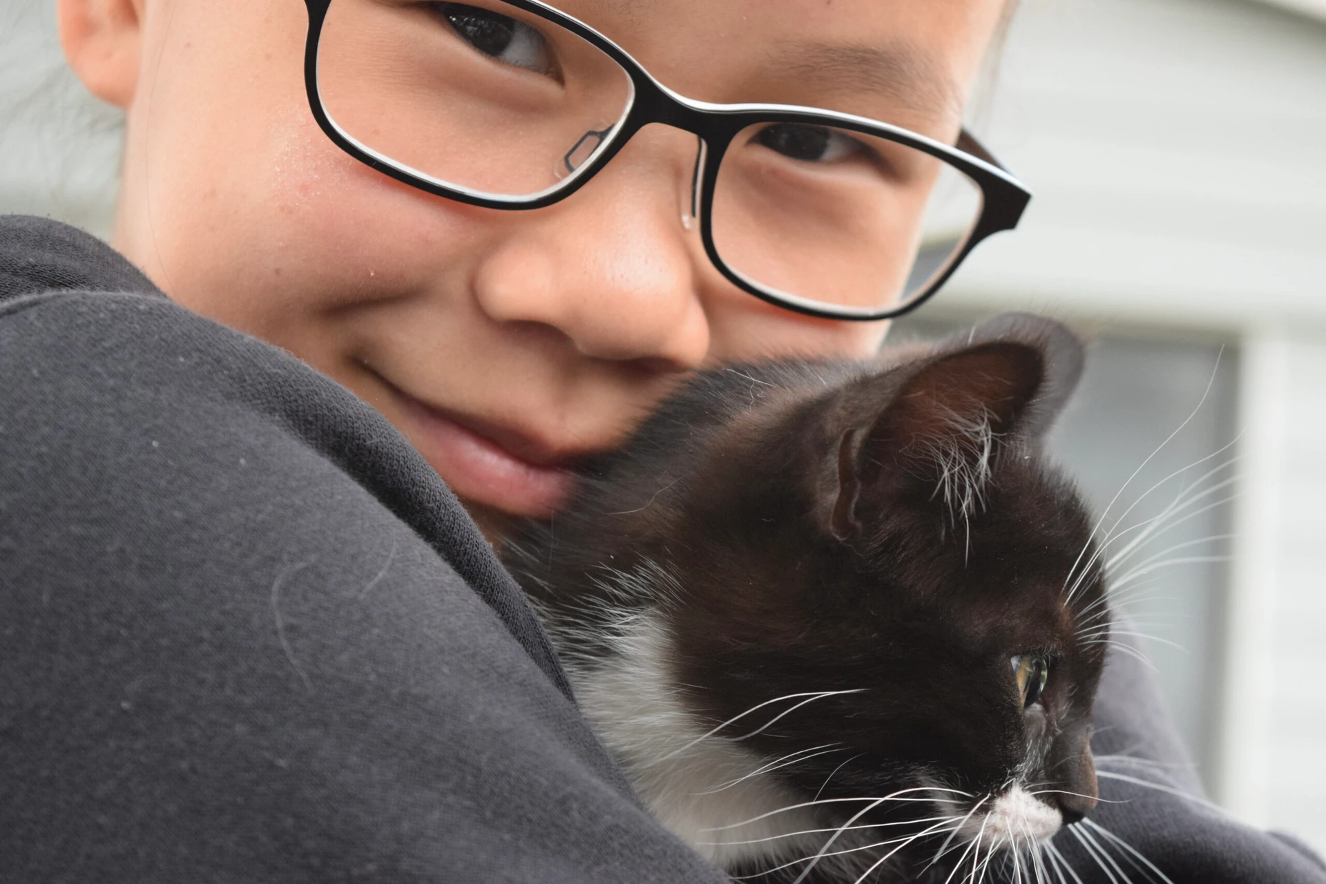 Teen volunteer cuddles with a kitten