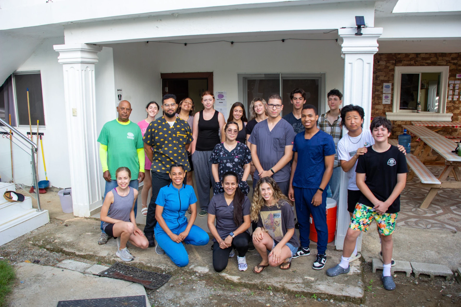 VISIONS teen volunteers, leaders and community members in the DR gathered outside the veterinary where spays & neuters were completed